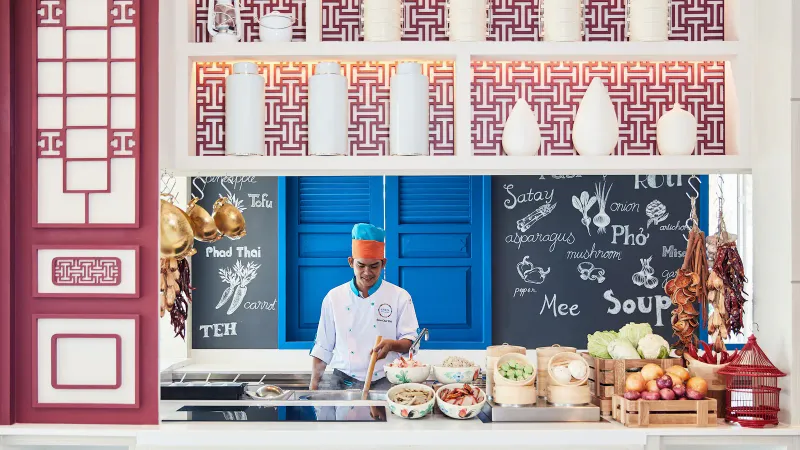 Chef at a live Thai cooking station in the Amaya Food Gallery at Amari Koh Samui