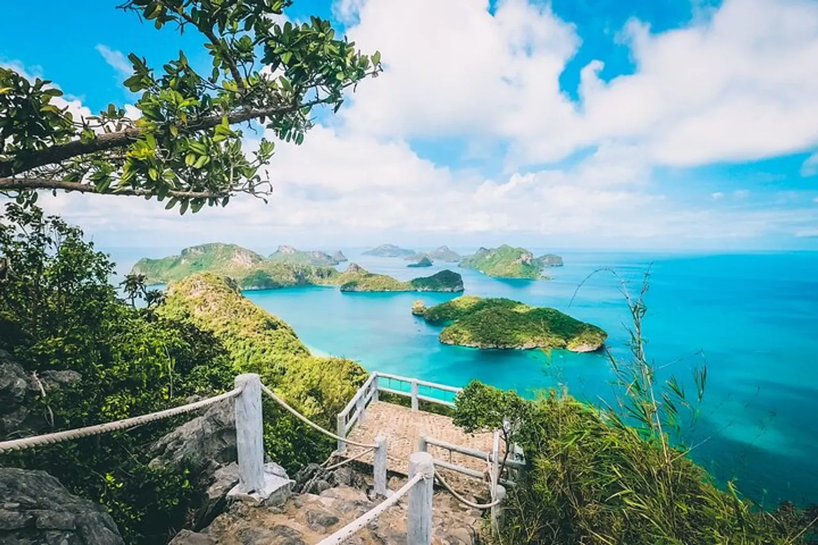 Tour boats crossing the channels between Ang Thong's limestone islands