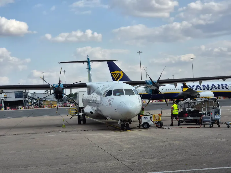ATR 72 turboprop being loaded on an airport apron, the aircraft type common on short Samui routes