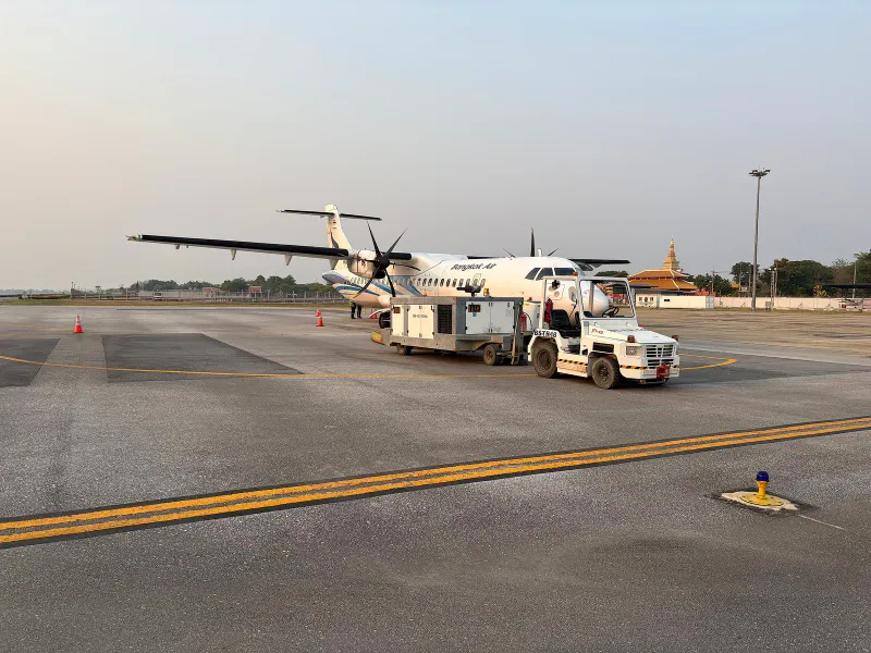 Bangkok Airways ATR 72-600 turboprop parked on an airport apron, the type used on short Samui routes