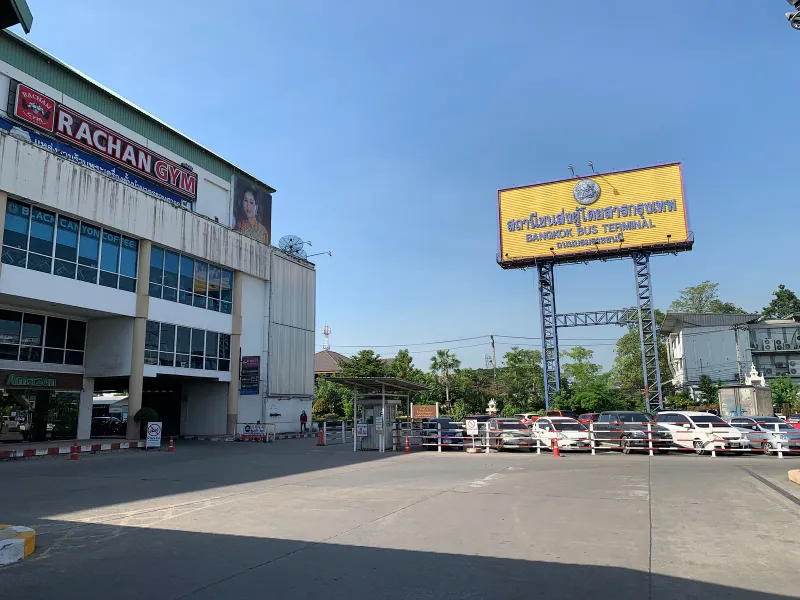 Yellow Bangkok Bus Terminal sign above a car park at the Southern Bus Terminal in Bangkok