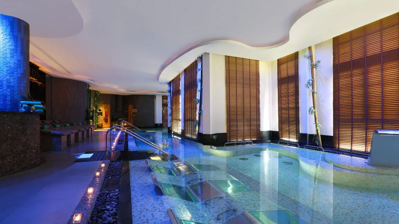 Banyan Tree Samui spa hydrotherapy pool with submerged loungers, bamboo and warm lighting
