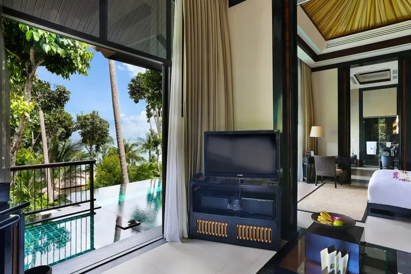 Banyan Tree Samui villa living area opening onto an infinity-edge private pool and jungle