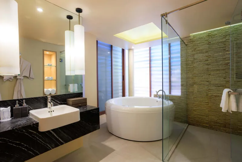 Room bathroom with marble basin, round soaking tub and glass shower at Chaweng Regent Beach Resort