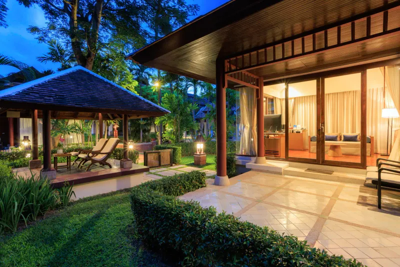 Garden villa terrace with lounge chairs and sliding glass doors at Chaweng Regent Beach Resort