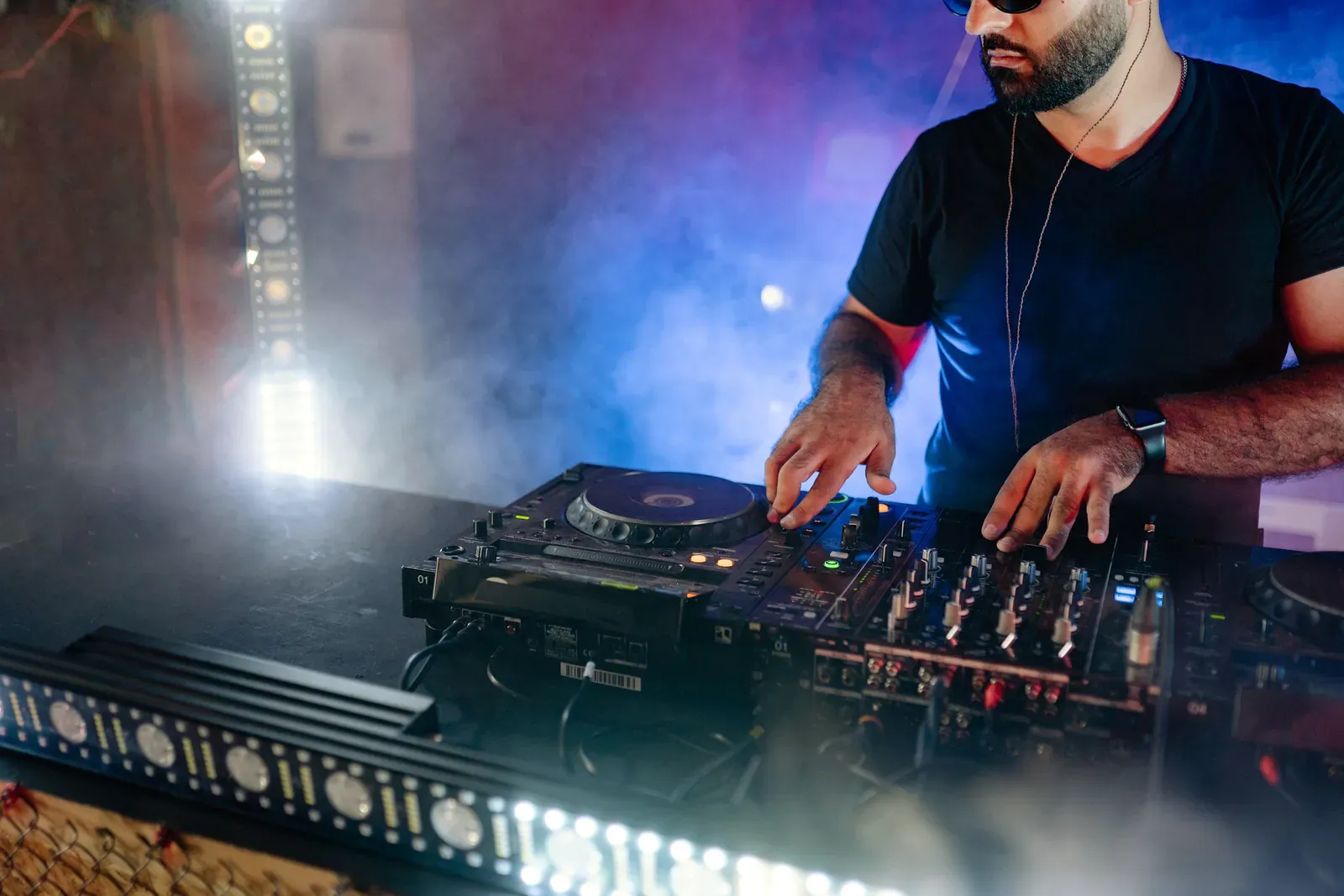 DJ playing a set in stage smoke