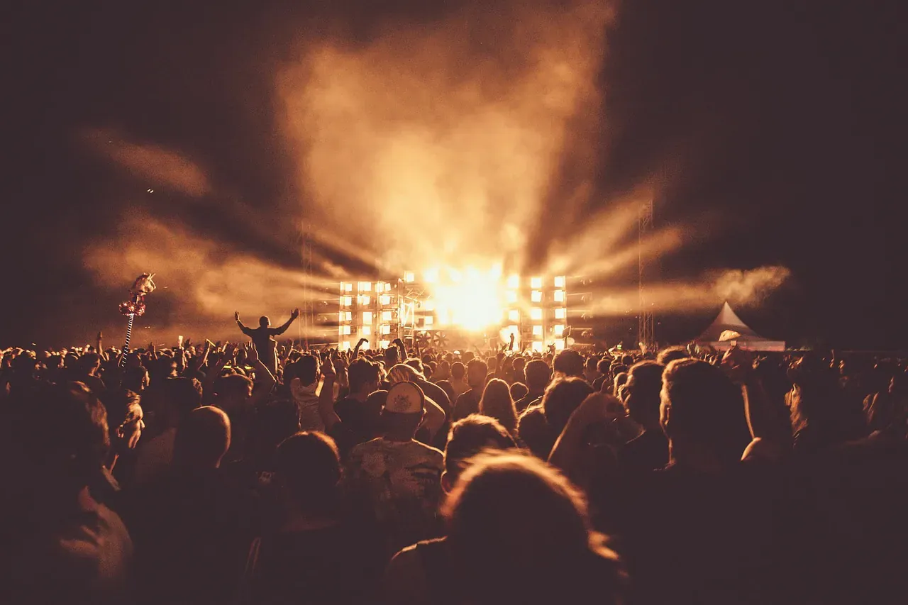 Light beams over a crowd at a night party