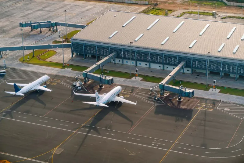Aerial view of an island airport runway and terminal, similar in scale to Koh Samui Airport