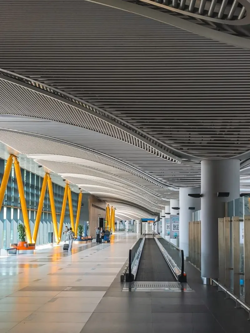 Bright airport terminal interior with high ceilings, representing a regional island airport