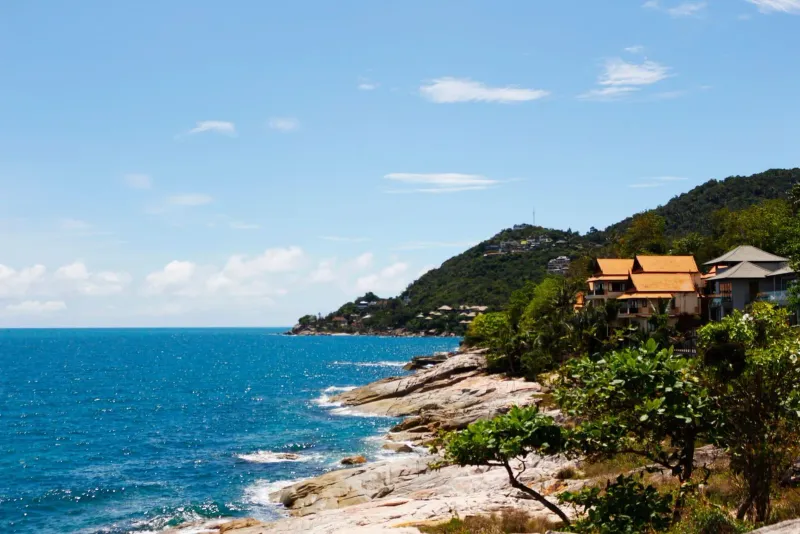 Lush green coastline and bright blue sea along Koh Samui's south coast near Laem Sor