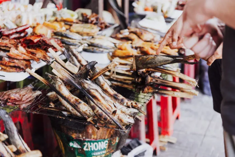 Grilled seafood skewers at a Koh Samui fish market stall prepared by local vendors