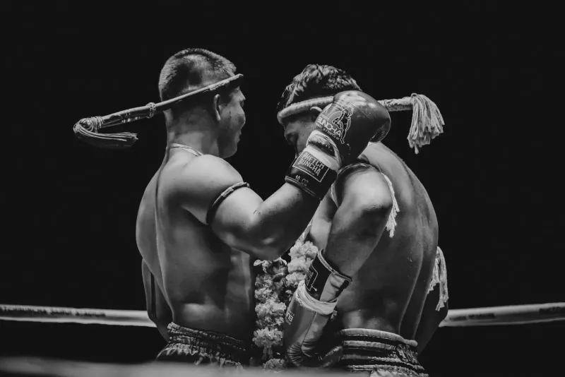 Muay Thai fighters competing under stadium lights during a fight card in Chaweng, Koh Samui