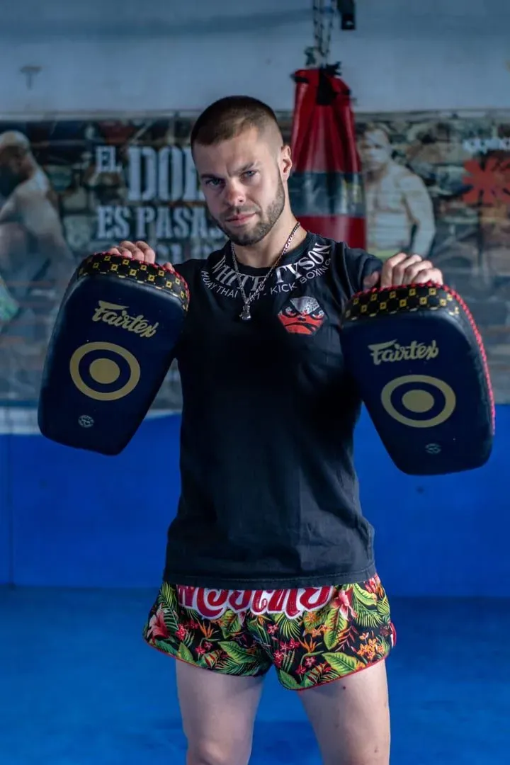 Muay thai student wrapping hands before a private training session at a Koh Samui gym
