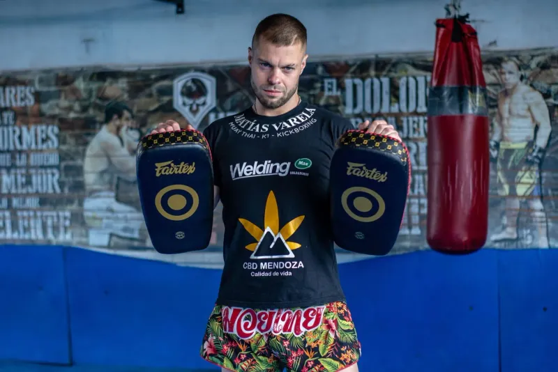 Kickboxer holding training pads during a one-on-one muay thai coaching session
