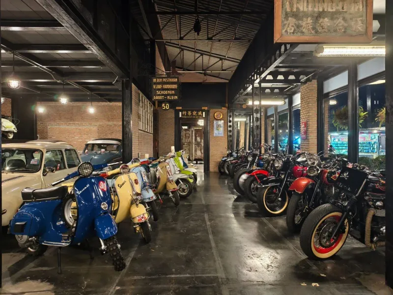Older motorcycles parked in a Koh Samui repair garage typical of the island's workshop culture