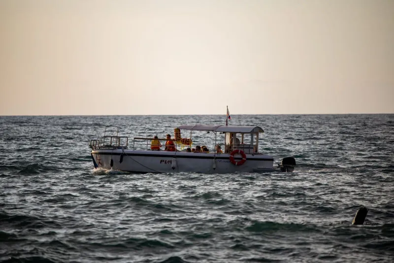 Boat passengers wearing life vests while crossing open water near Koh Samui