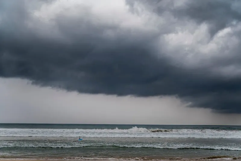 Dark storm clouds building over rough sea waves, typical of Koh Samui's northeast monsoon swell