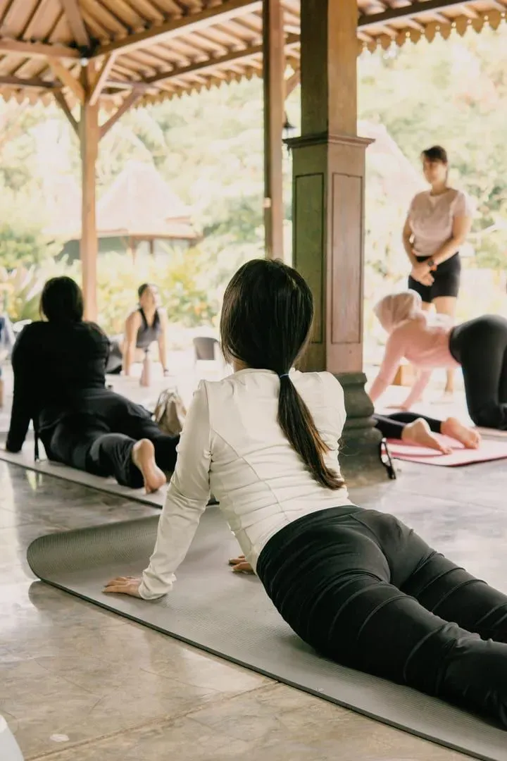 Participants in a tranquil outdoor group yoga session near Koh Samui