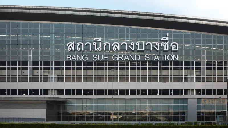 Front facade of Bang Sue Grand Station in Bangkok with Thai and English signage