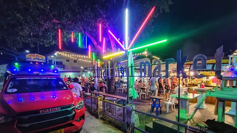 Colourful lights over a night market bar area
