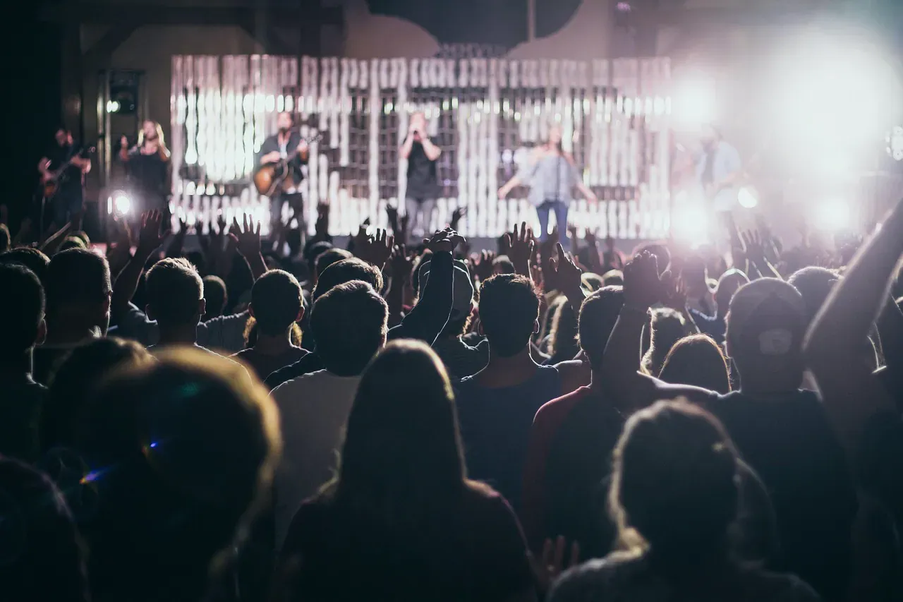 Crowd watching a band on a festival stage