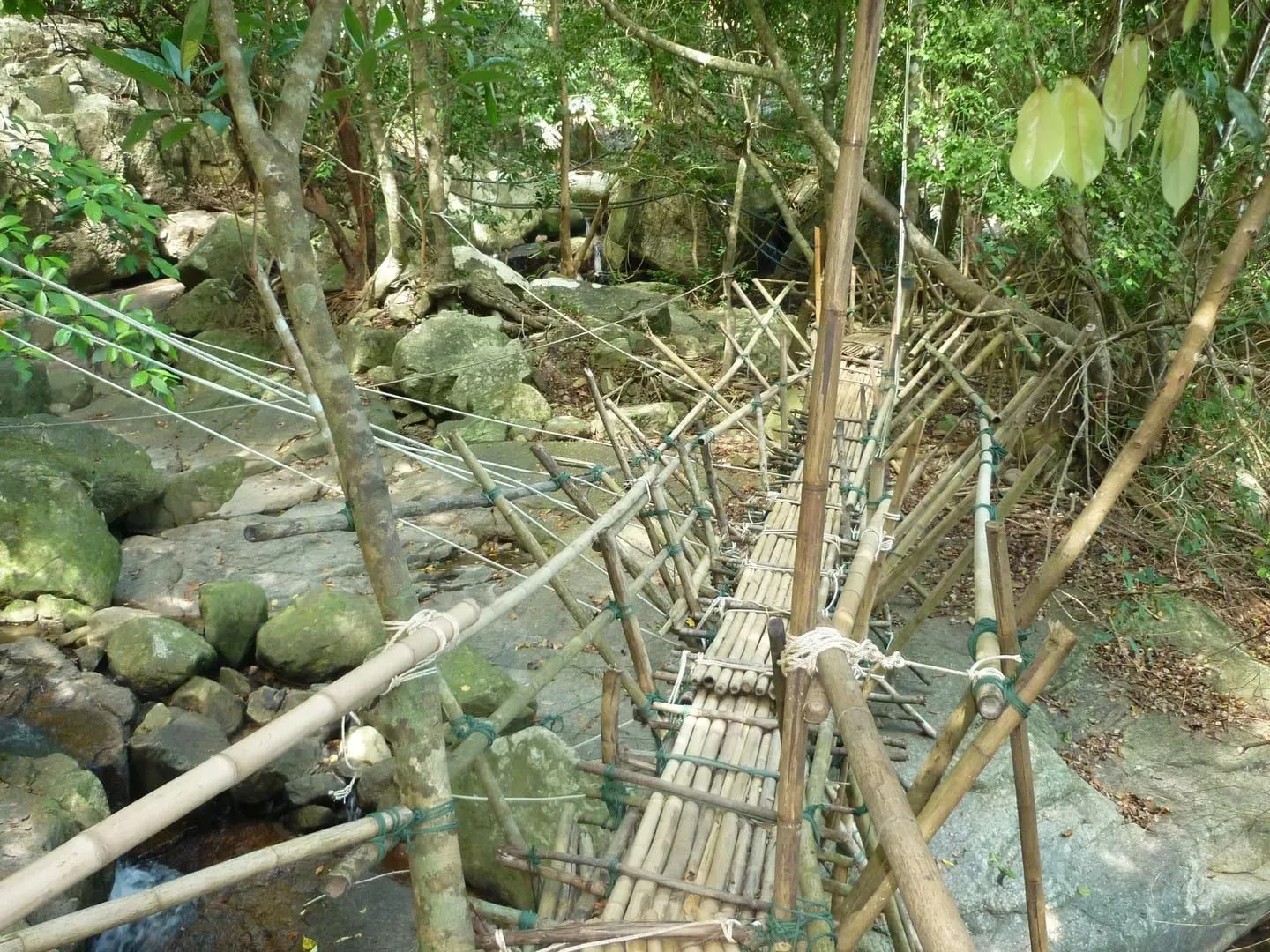 Visitors swimming in the natural pool at Na Muang Waterfall
