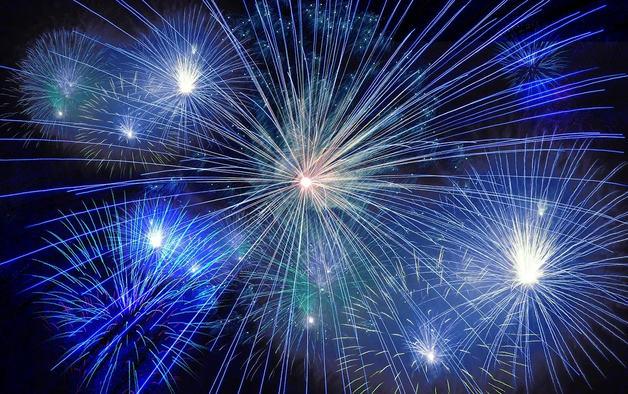 Blue fireworks bursting in the night sky