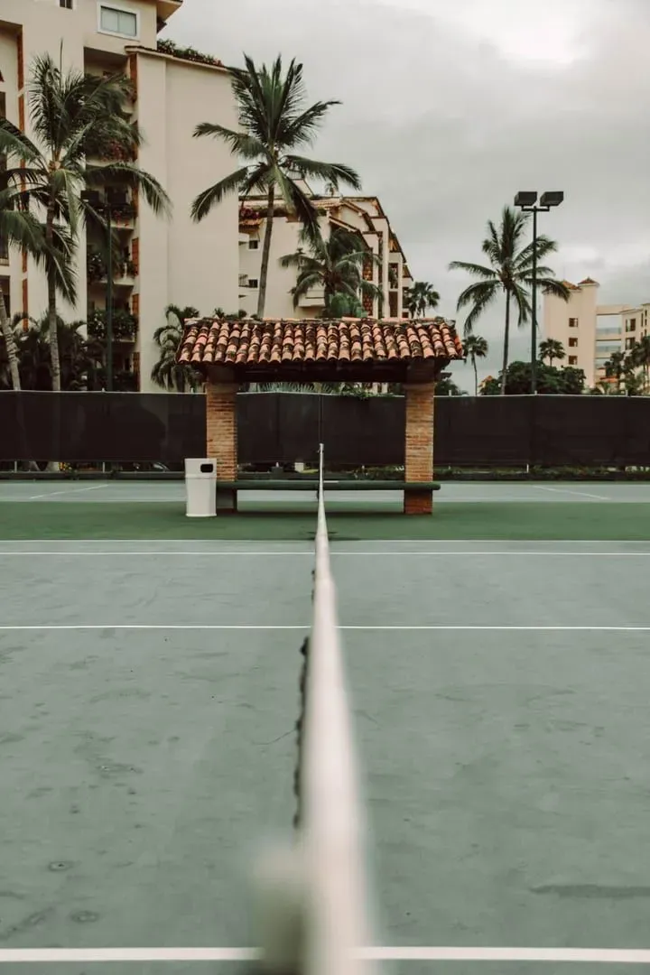 Tropical court with a shaded courtside shed, the kind of open-air setup Padel Tropical runs alongside its covered courts