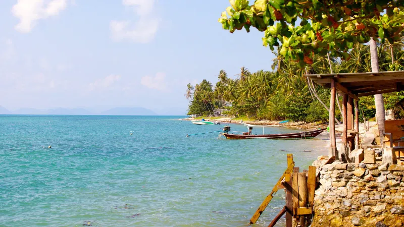 Longtail boats resting on the sand at low tide, Phang Ka
