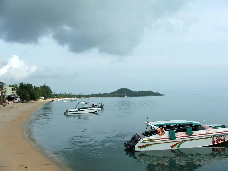 Longtail and speedboats anchored in a calm bay off Koh Samui's north coast