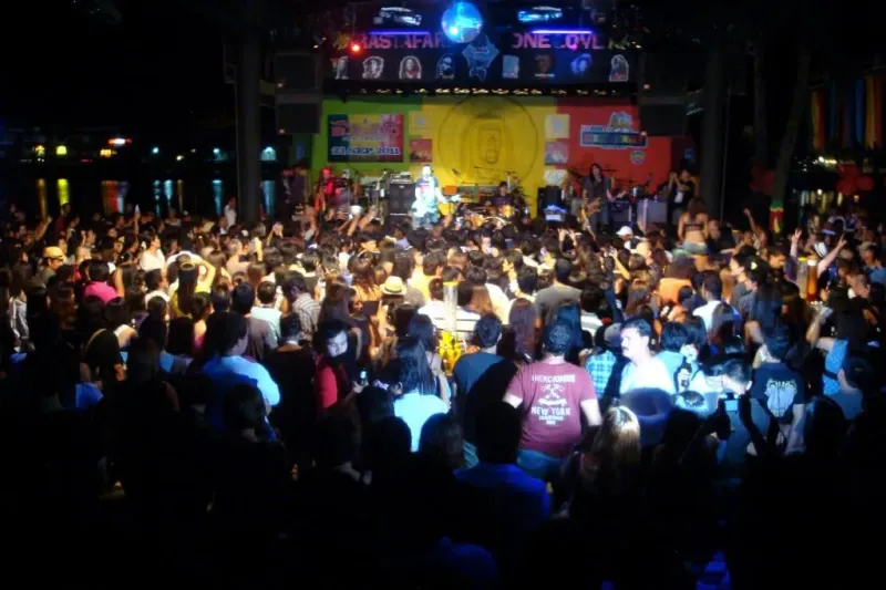 Crowd watching a live band perform on the lakeside stage at Reggae Pub, Chaweng, Koh Samui