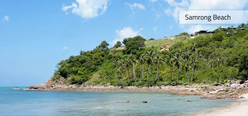 Samrong Beach framed by a forested headland and coconut palms