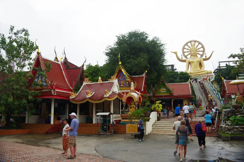 Golden seated Big Buddha statue at Wat Phra Yai on Koh Samui under a blue sky