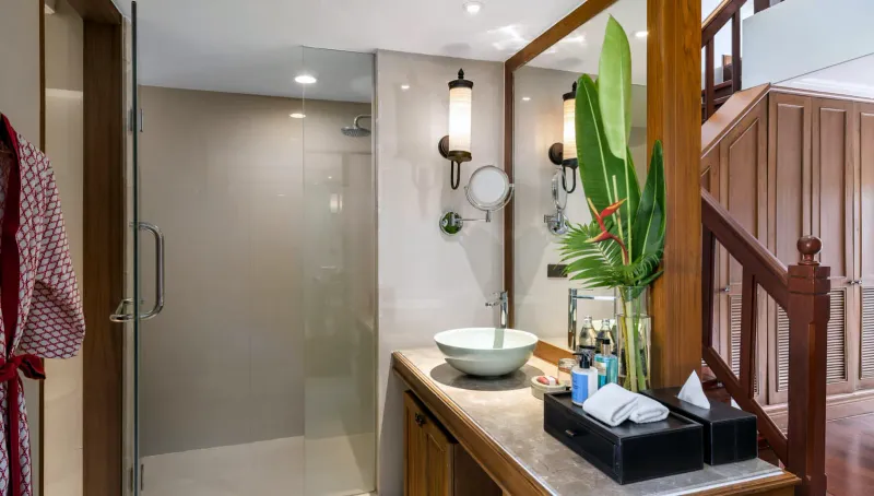 Bathroom with glass shower, stone vanity and vessel basin in a room at Santiburi Koh Samui