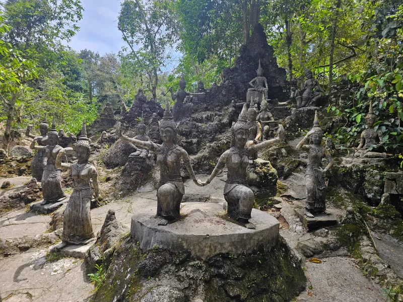 Close-up of a smiling stone goddess statue at Tarnim Magic Garden