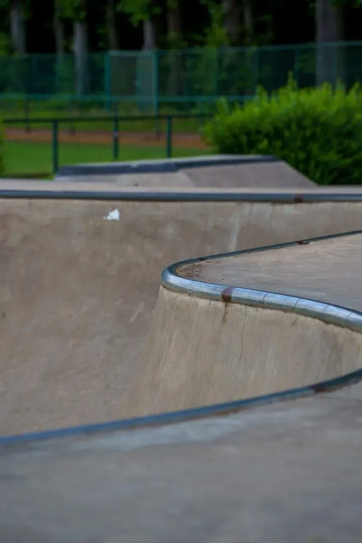 Curved concrete skate ramp in a green outdoor setting, the kind of park Maenam's Eternal skatepark offers on Koh Samui