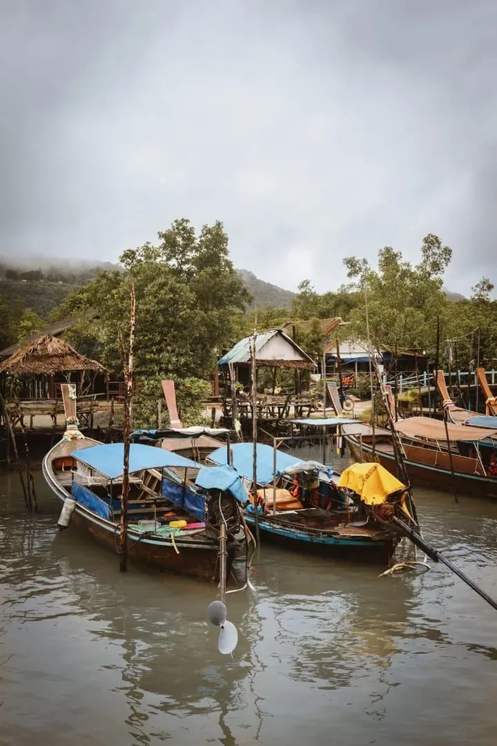 Traditional longtail boats moored at a dock in southern Thailand