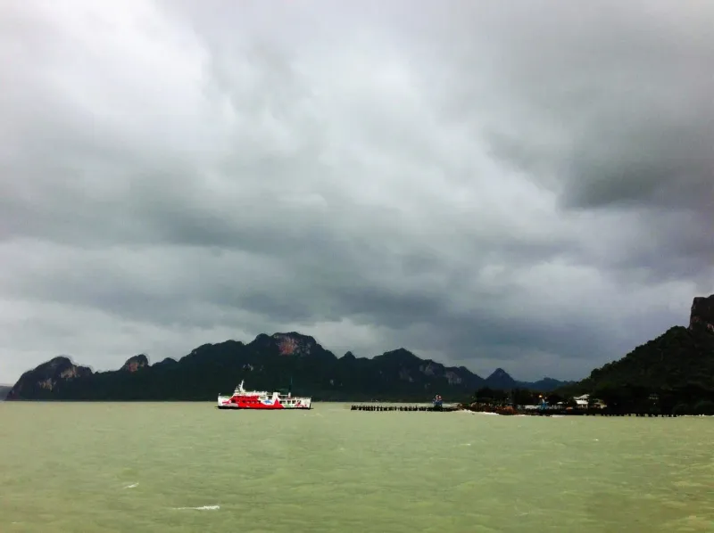 Ferry crossing choppy water in the Gulf of Thailand under a cloudy sky