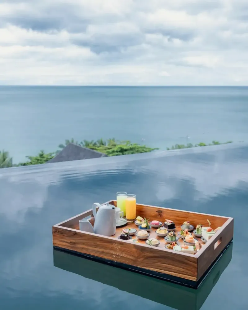 Floating breakfast tray on a Vana Belle private pool with the sea in the background