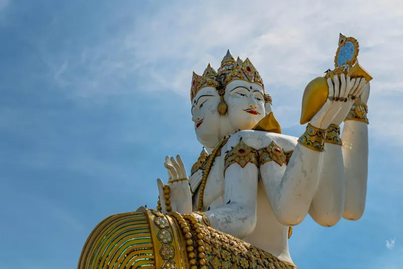 Close-up of the 18-armed Guanyin statue's crowned heads and raised hands at Wat Plai Laem
