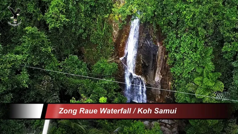 Aerial drone view of Zong Raue Waterfall dropping through the jungle canopy